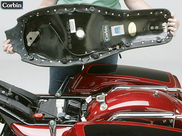 a person holding Gambler Seat showing rear side with MPN printed, keylock system and mounting brackets pre-installed