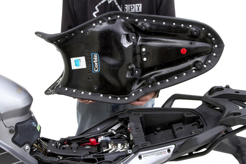 a person is holding Gunfighter seat showing rear side mounting brackets preinstalled