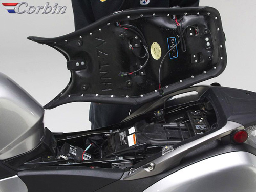 a person is holding Canyon Sport Dual Seat showing rear side MPN printed and wiring harness