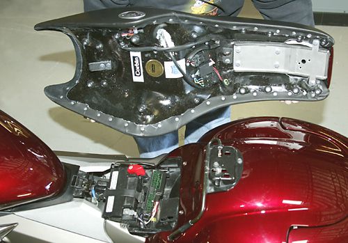 a person is holding Rumble Seat showing rear side MPN printed and mounting brackets pre-installed