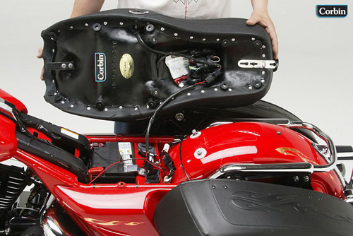 a person is hodling dual tour seat showing rear side mounting brackets pre-installed
