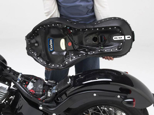 a person is holding Dual Tour seat showing rear side with mounting brackets preinstalled