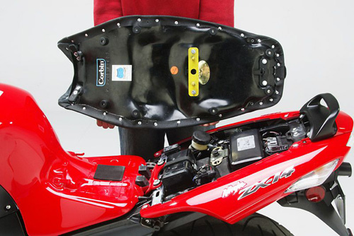  a person is holding seat showing rear side mounting brackets pre-installed