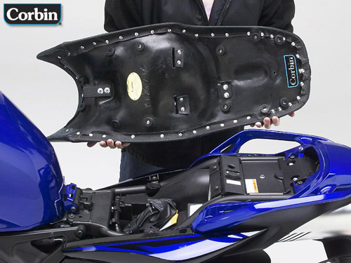 a person is holding Gunfighter seat showing rear side MPN printed and mounting brackets pre-installed