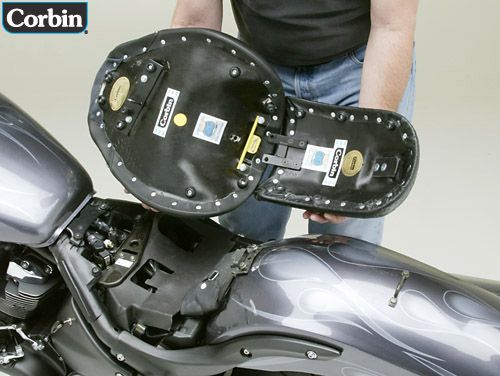 a person is holding Solo and pillio showing rear side with MPN printed and mounting brackets pre-installed