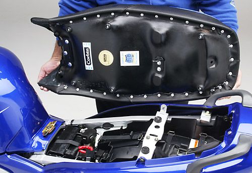 a person is holding Gunfighter seat showing rear side MPN printed and mounting brackets pre-installed