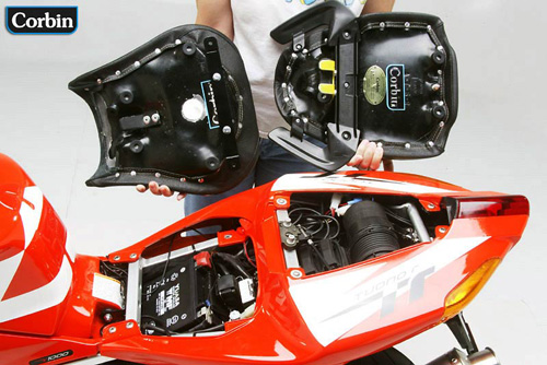 a person is holding front and rear seat showing rear side mounting brackets pre-installed