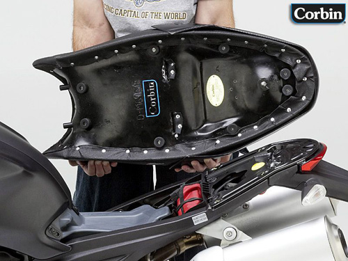 a person is holding Dual seat showing rear side MPN printed and mountin brackets pre-installed