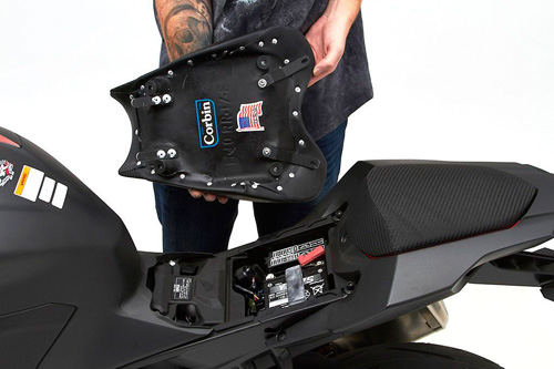 a person is holding front seat showing rear side MPN printed and mounting brackets pre-installed