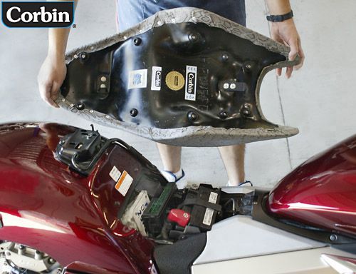 a person is holding Fast Gun seat showing rear side MPN printed and mounting brackets pre-installed