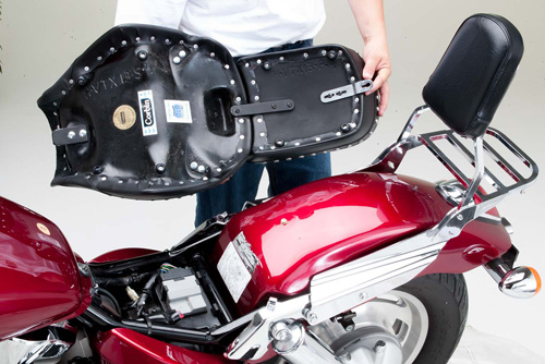 a person is holding front and rear seat together showing rear side MPN printed and mounting brackets pre-installed