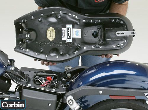a person is holding Gunfighter seat showing rear side MPN printed and mounting brackets pre-installed