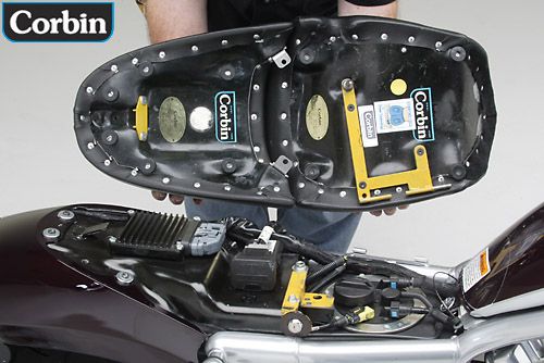 a person is holding front and rear seat showing rear side with mounting bracket pre-installed