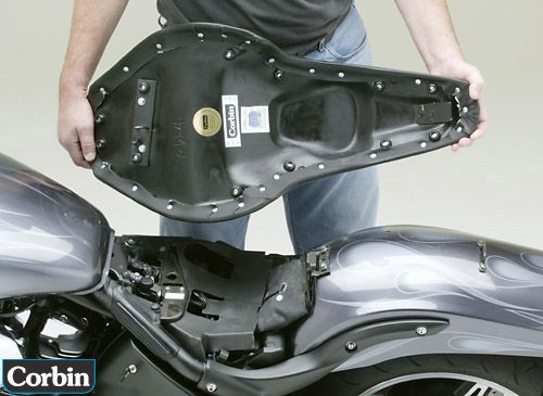 a person is holding Stinger seat showing basepan with MPN printed and mounting brackets pre-installed