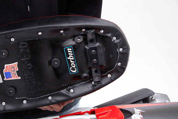 a person is holding dual sport seat showing basepan, zoomed into the rear bracket which will transfer onto the seat