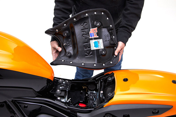 a person is holding Classic solo seat showing basepan with MPN printed and mounting brackets pre-installed