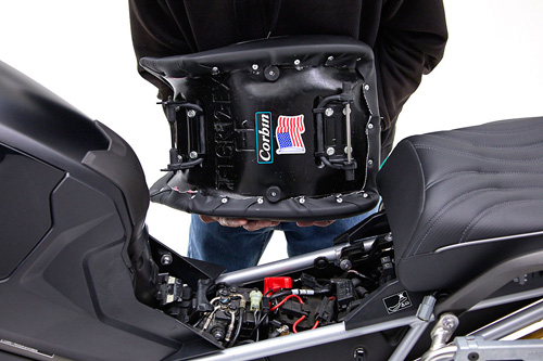 a person is holding front seat showing rear side MPN printed and mounting brackets pre-installed