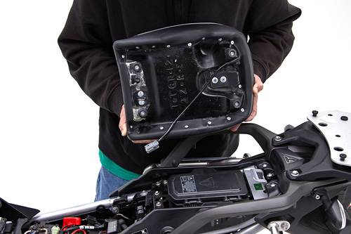 a person is holding rear seat showing rear side MPN printed, Heater wiring and mounting brackets pre-installed