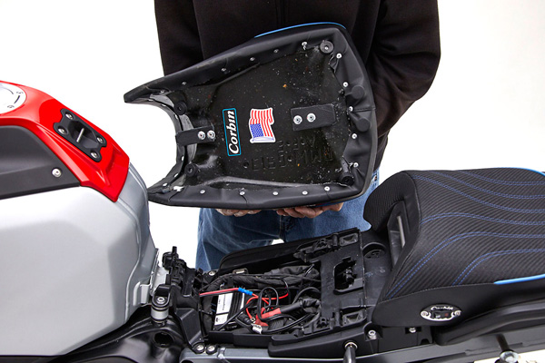 a person is holding front seat showing rear side MPN printed and mounting brackets pre-installed