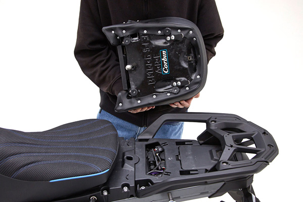 a person is holding rear seat showing rear side MPN printed and mounting brackets pre-installed