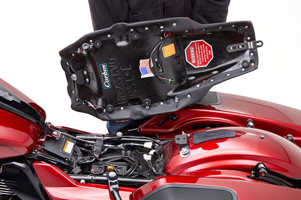 a person is showing the rear side of the seat MPN printed and mounting brackets pre-installed