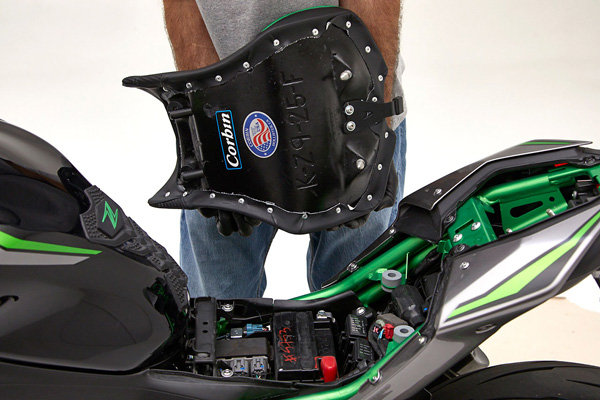 a passenger is holding the seat, showing rear side MPN printed and mounting brackets pre-installed